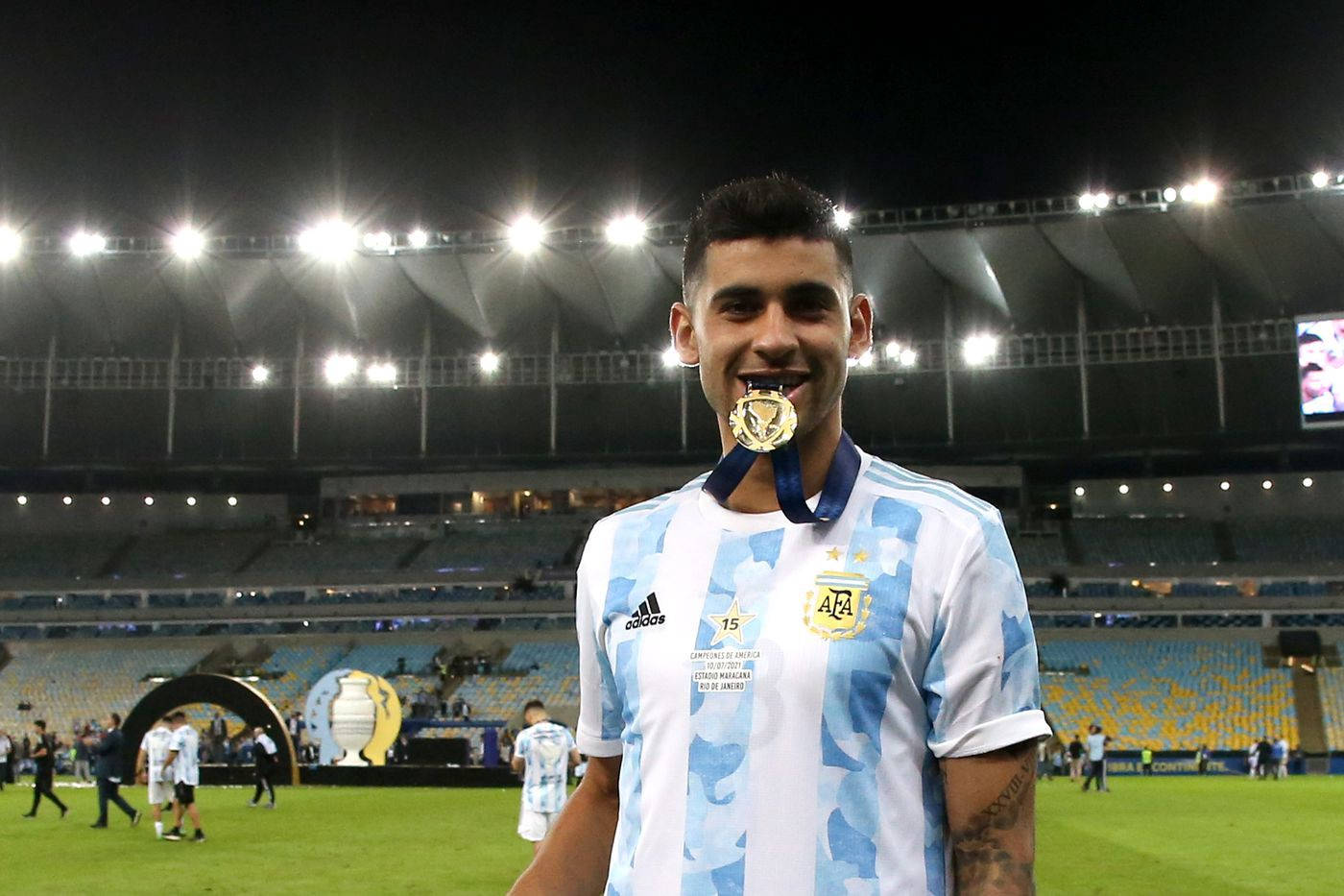 Cristian Romero Biting A Medal Background