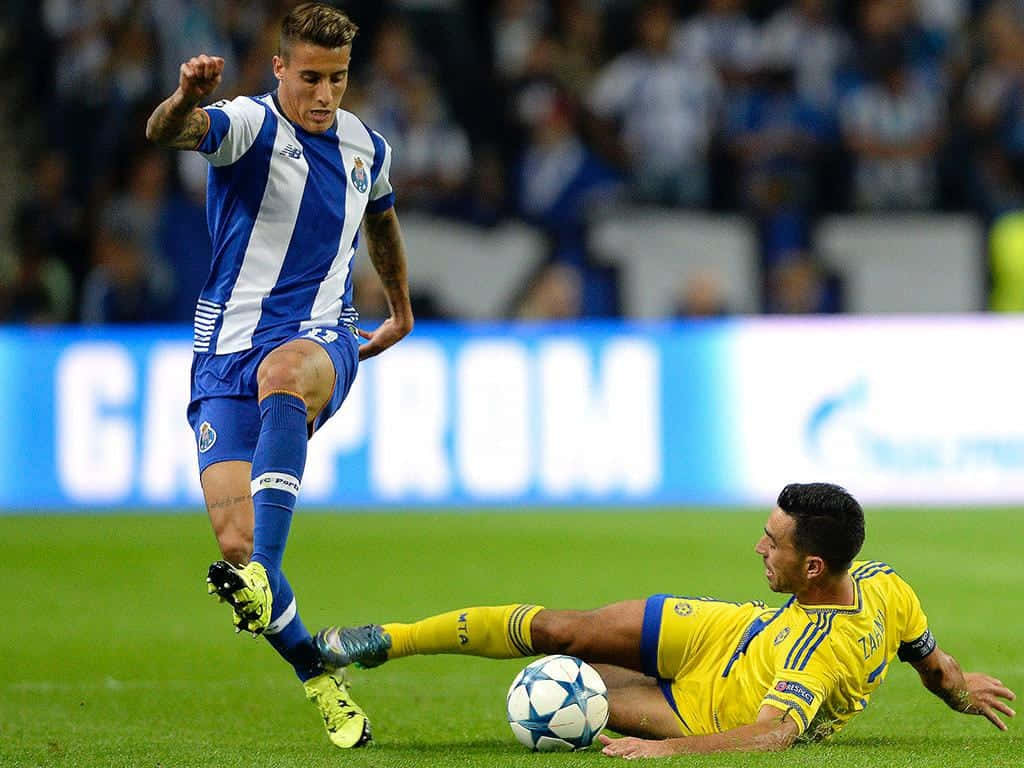 Cristian Tello Dodging Tackle Football Match Background