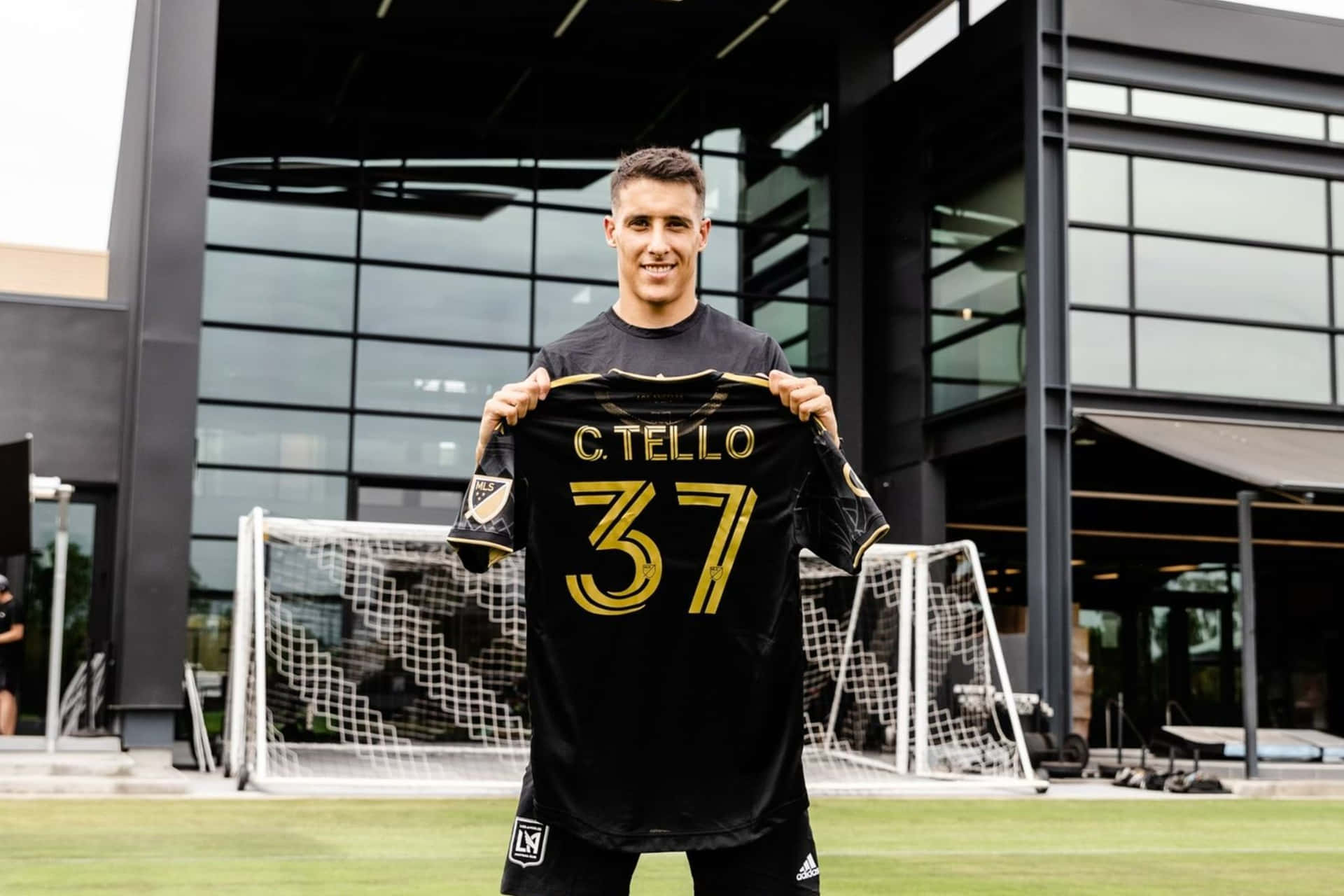 Cristian Tello Holding Jersey Number37 Background