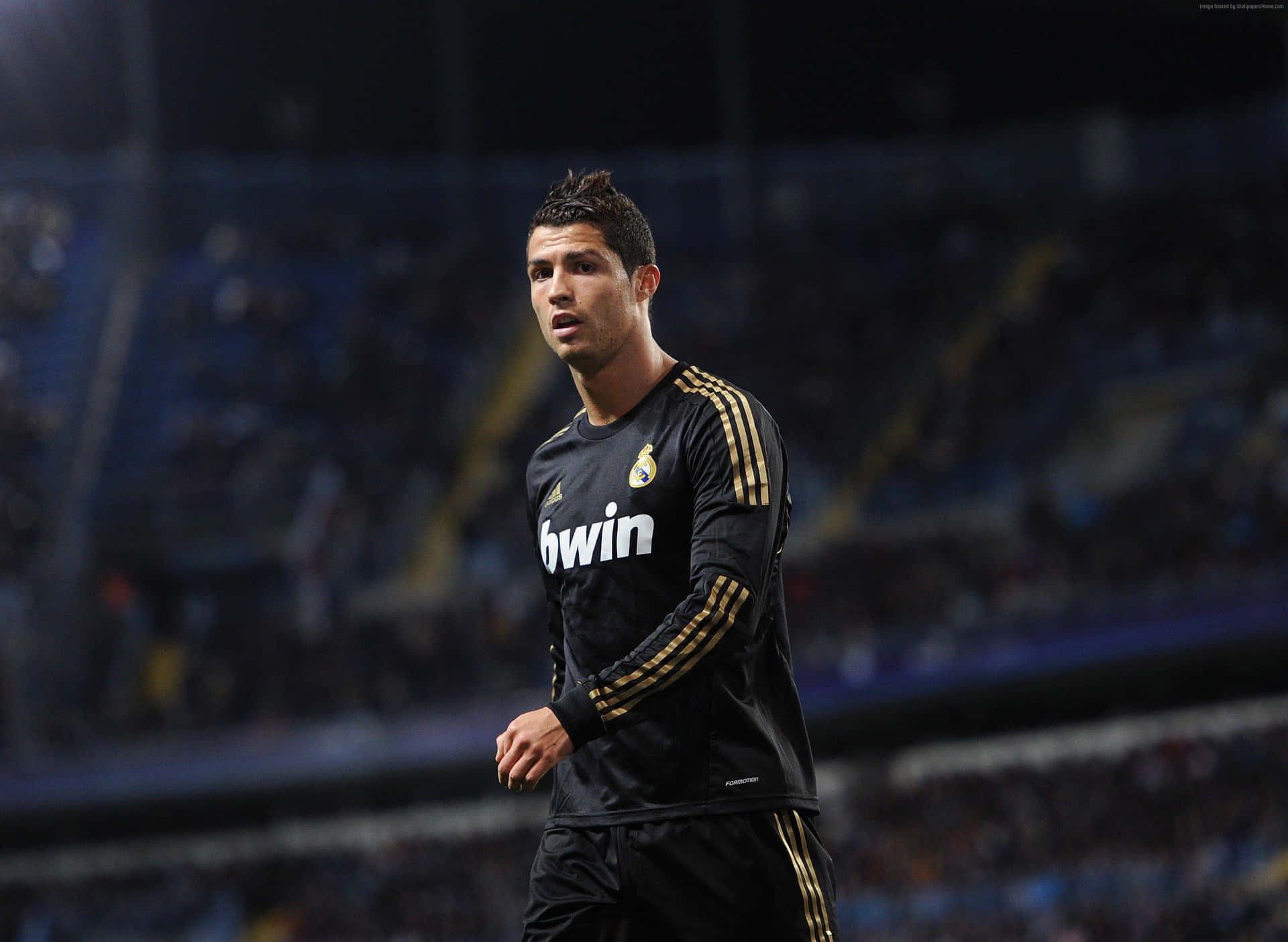 Cristiano Ronaldo Takes The Ball Down The Pitch During A Soccer Match Background