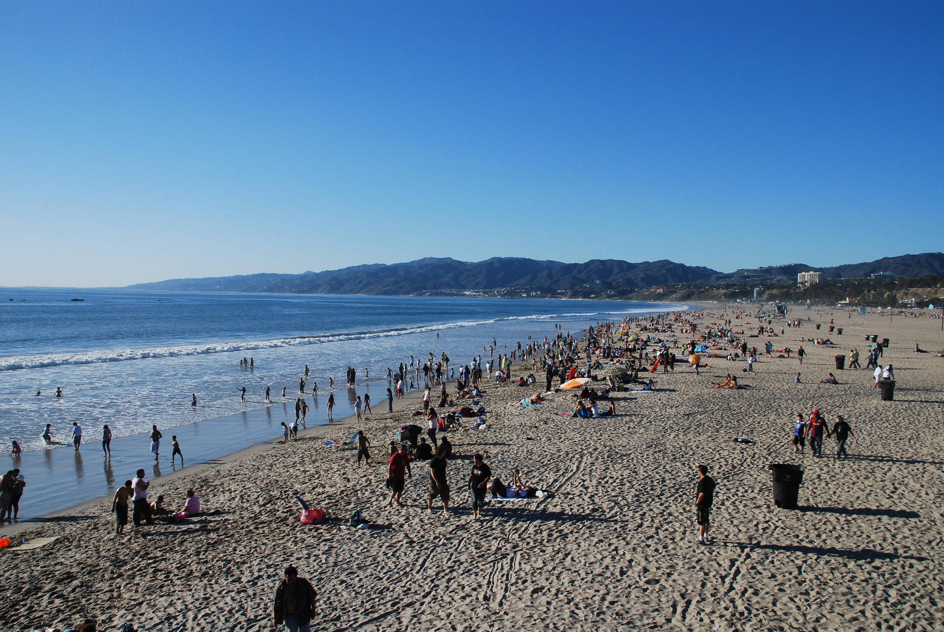 Crowd Of People At Malibu Beach Background