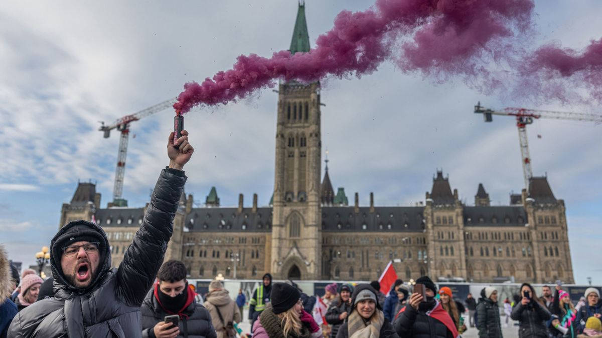 Crowd Of People Gathered In Ottawa Parliament Hill Background