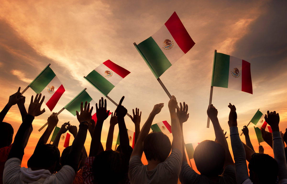 Crowd Of People With Mexican Flags Background