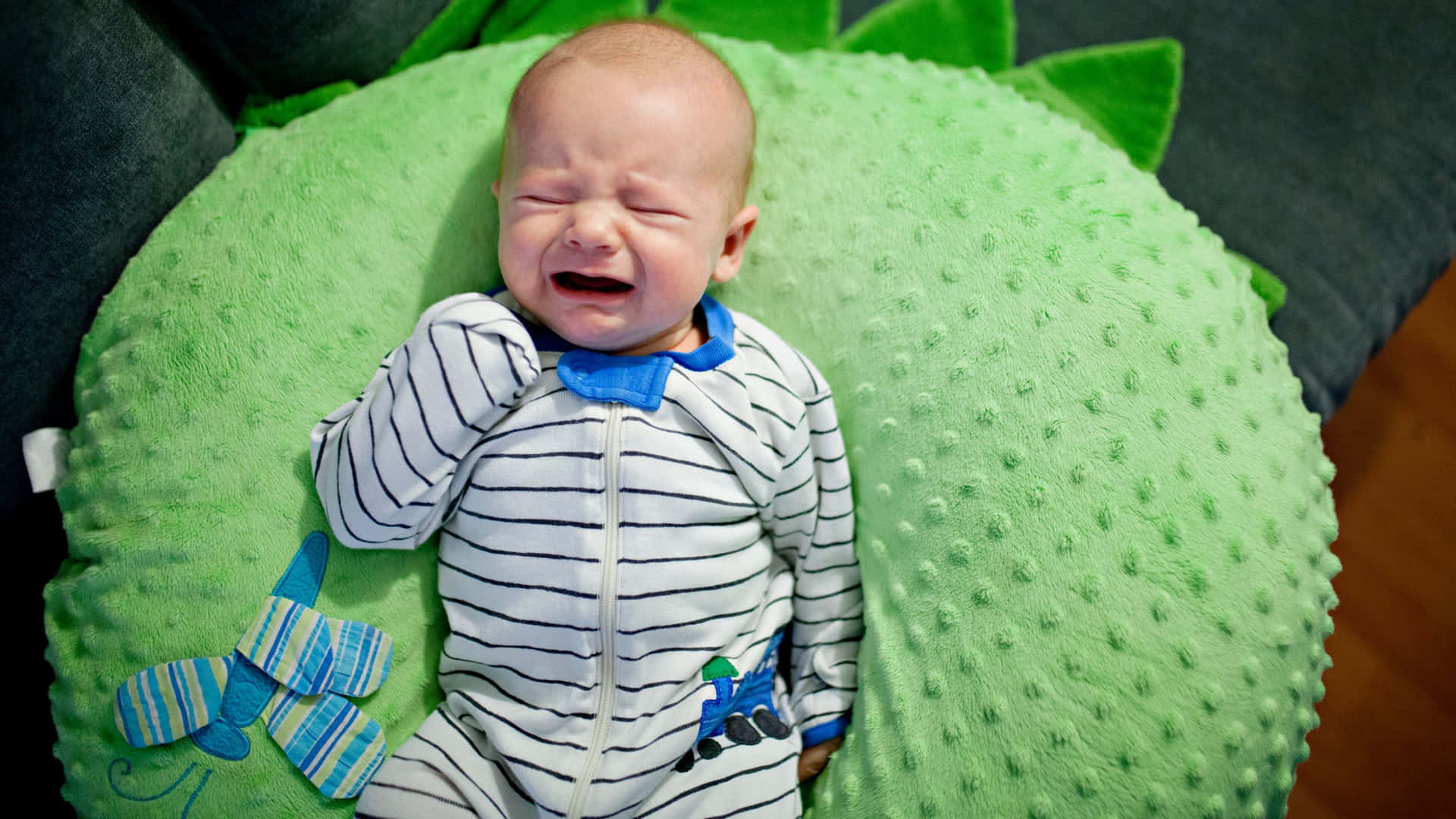 Crying Baby On Green Pillow.jpg