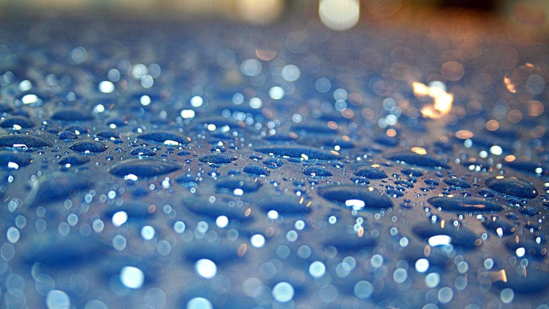 Crystal Like Raindrops On A Blue Surface Background
