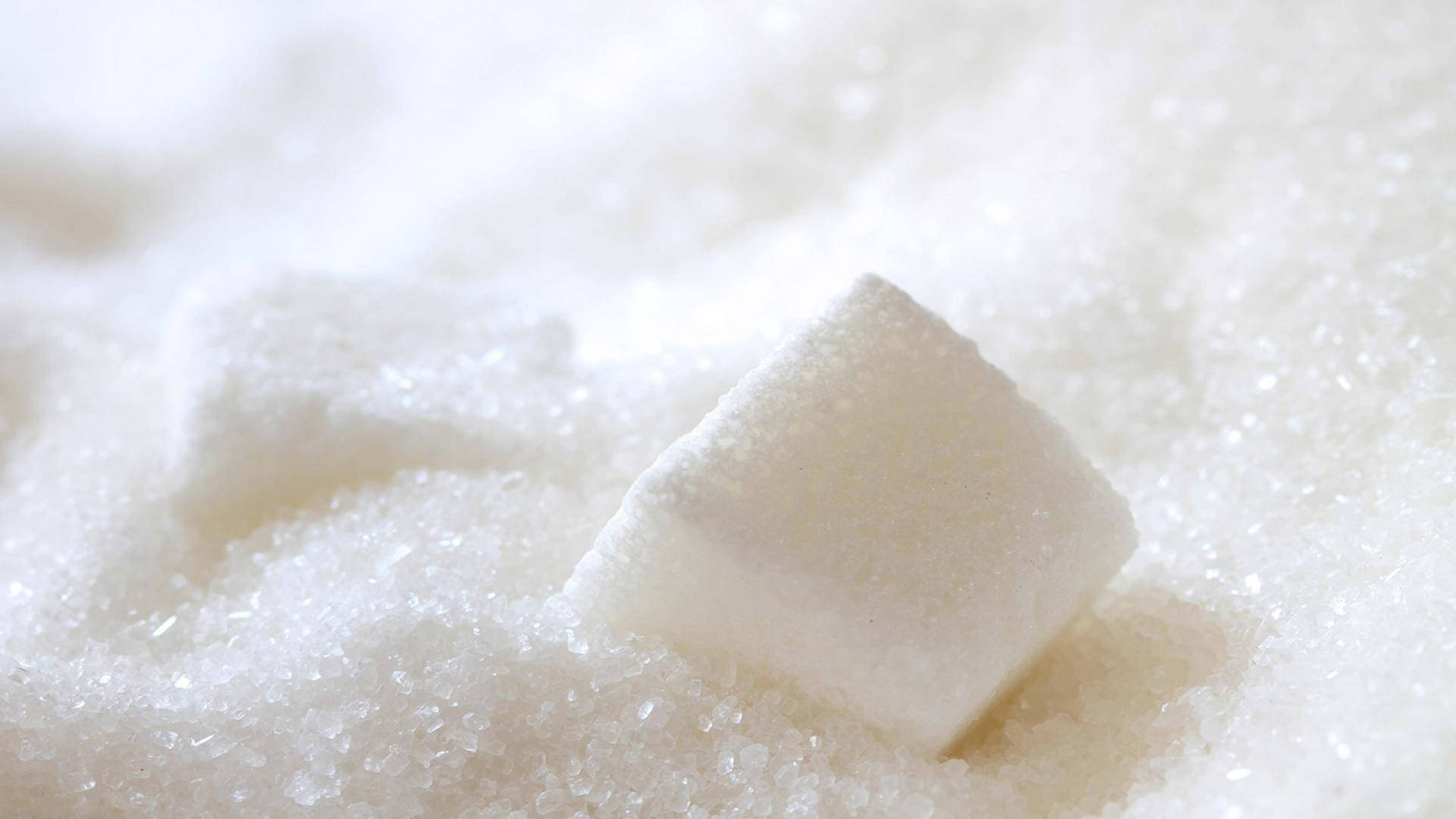 Cubes Amidst A Mountain Of Granulated Sugar Background