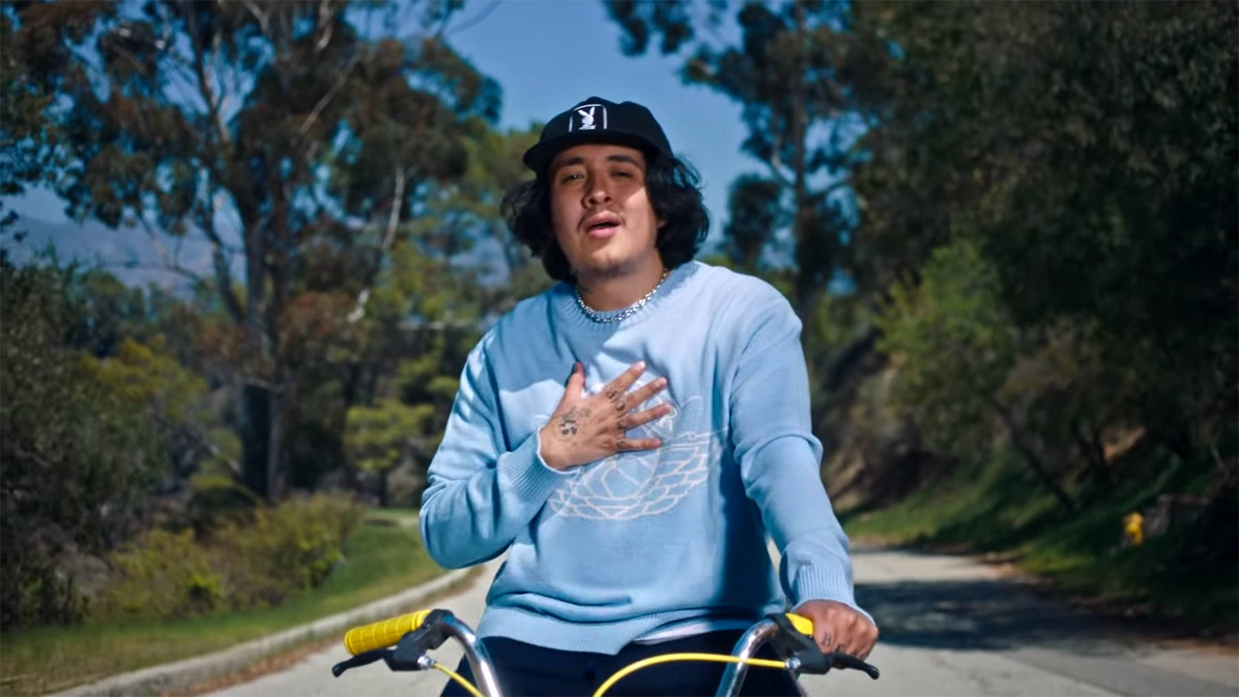 Cuco Riding A Bike Background