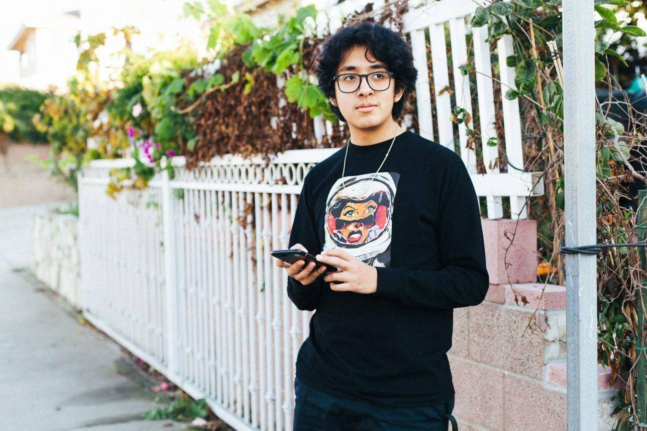 Cuco Standing Beside The Street Background