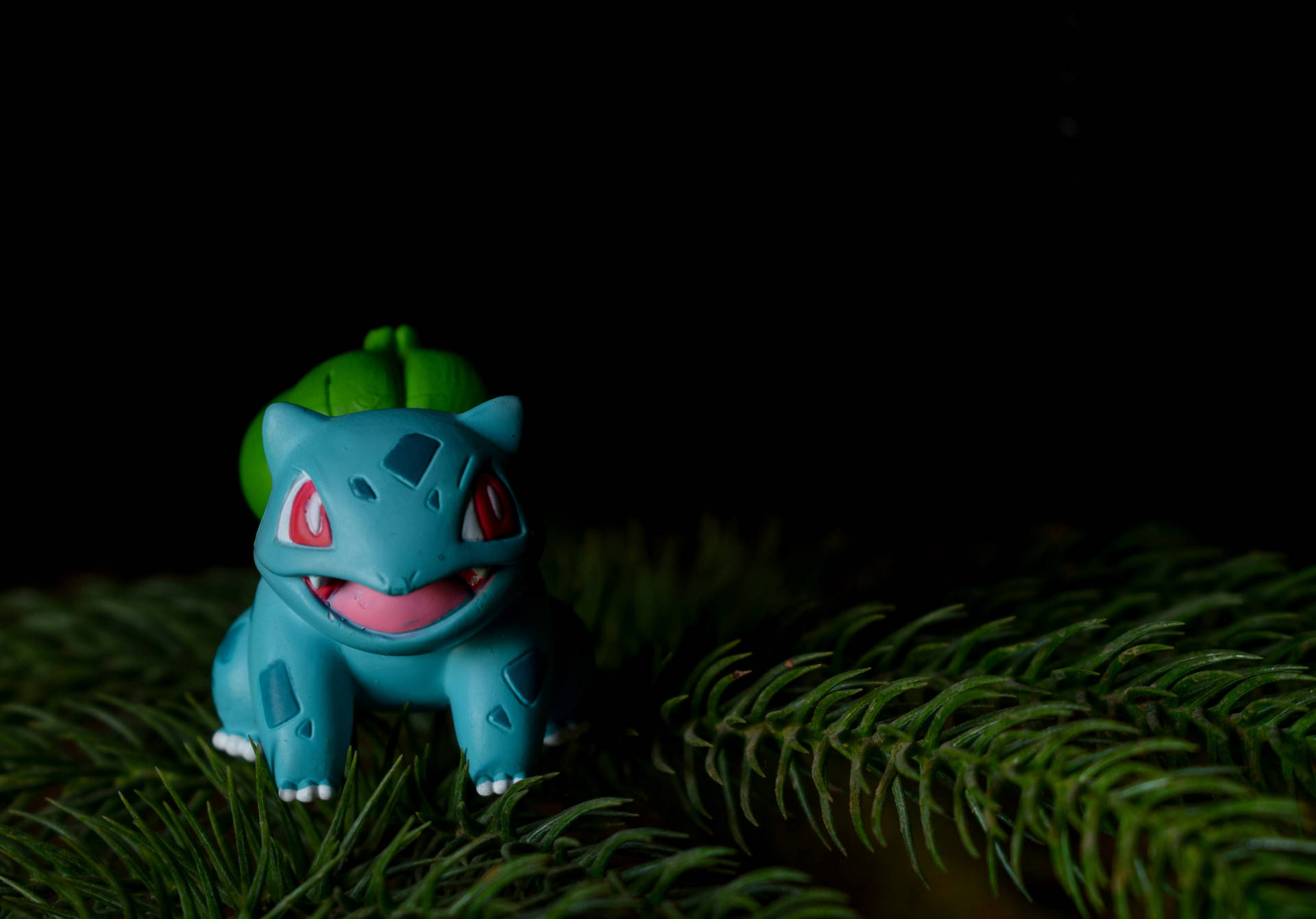 Cuddly Bulbasaur Toy Enjoying A Snack In The Pine Forest Background
