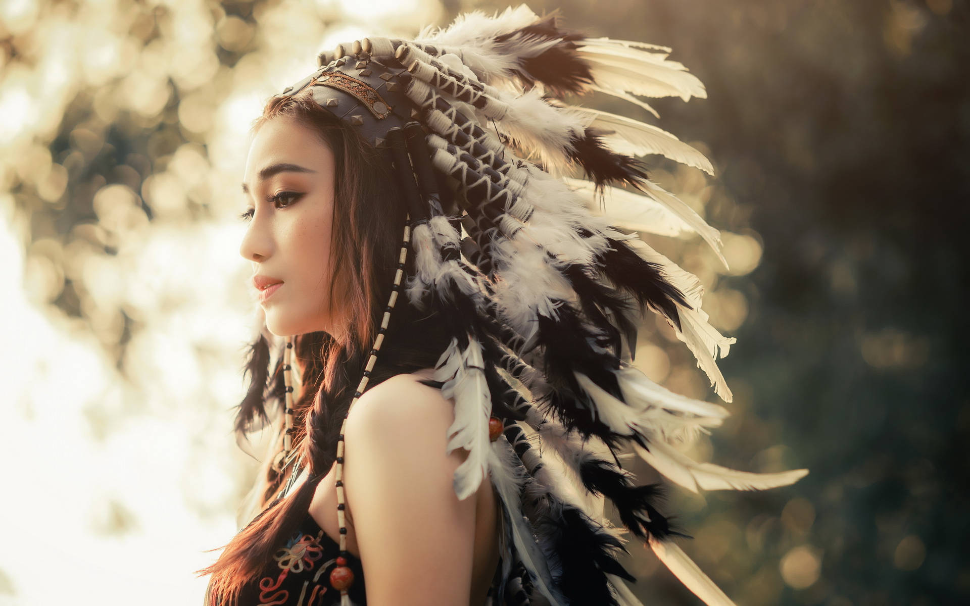 Cultural Fusion: Radiant Asian Woman Wearing Native American War Bonnet Background