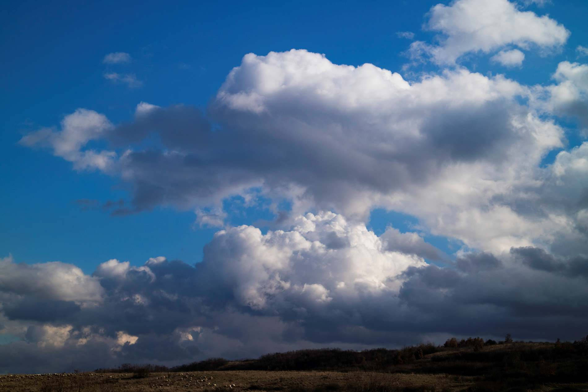 Cumulus Clouds And Hills Horizon Background