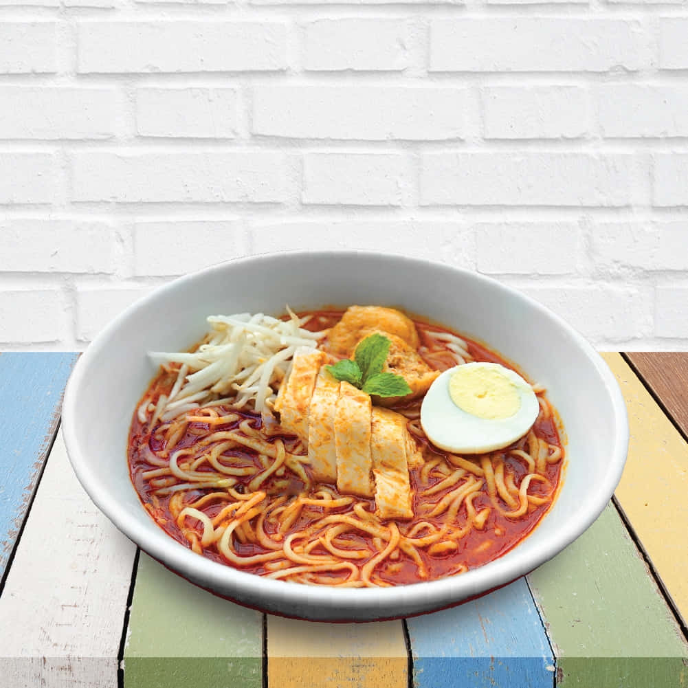 Curry Laksa On Colorful Wooden Table