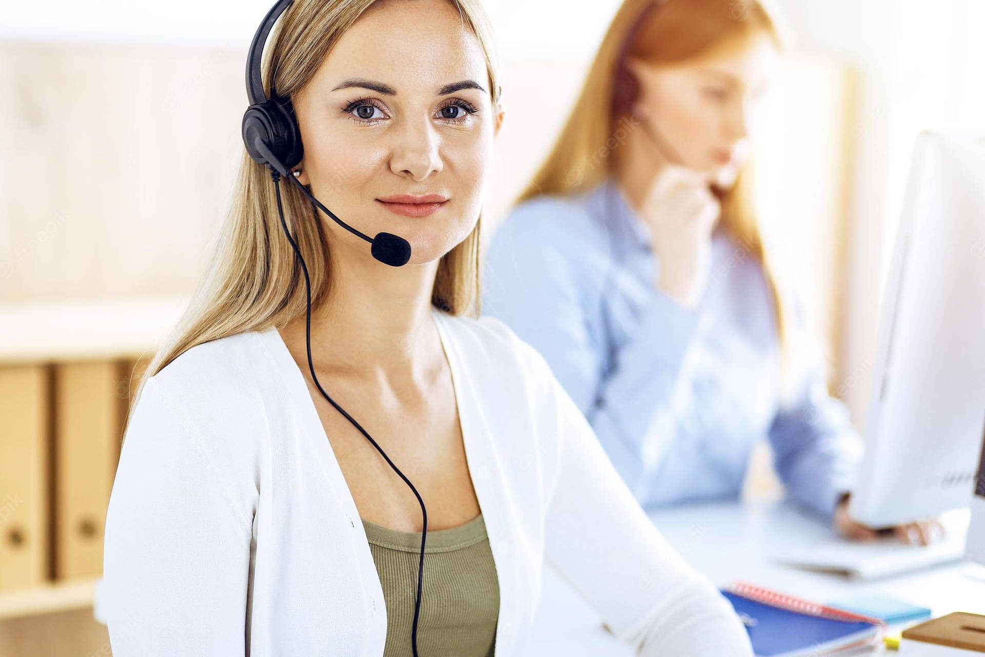 Customer Service Phone Operator Working At Her Desk Background