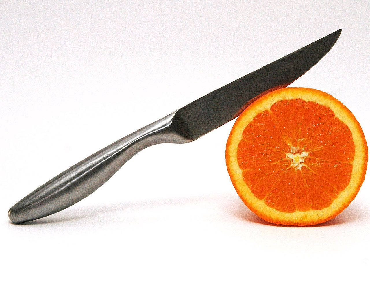 Cut Open, An Orange Provides A Refreshing Burst Of Natural Sweetness.