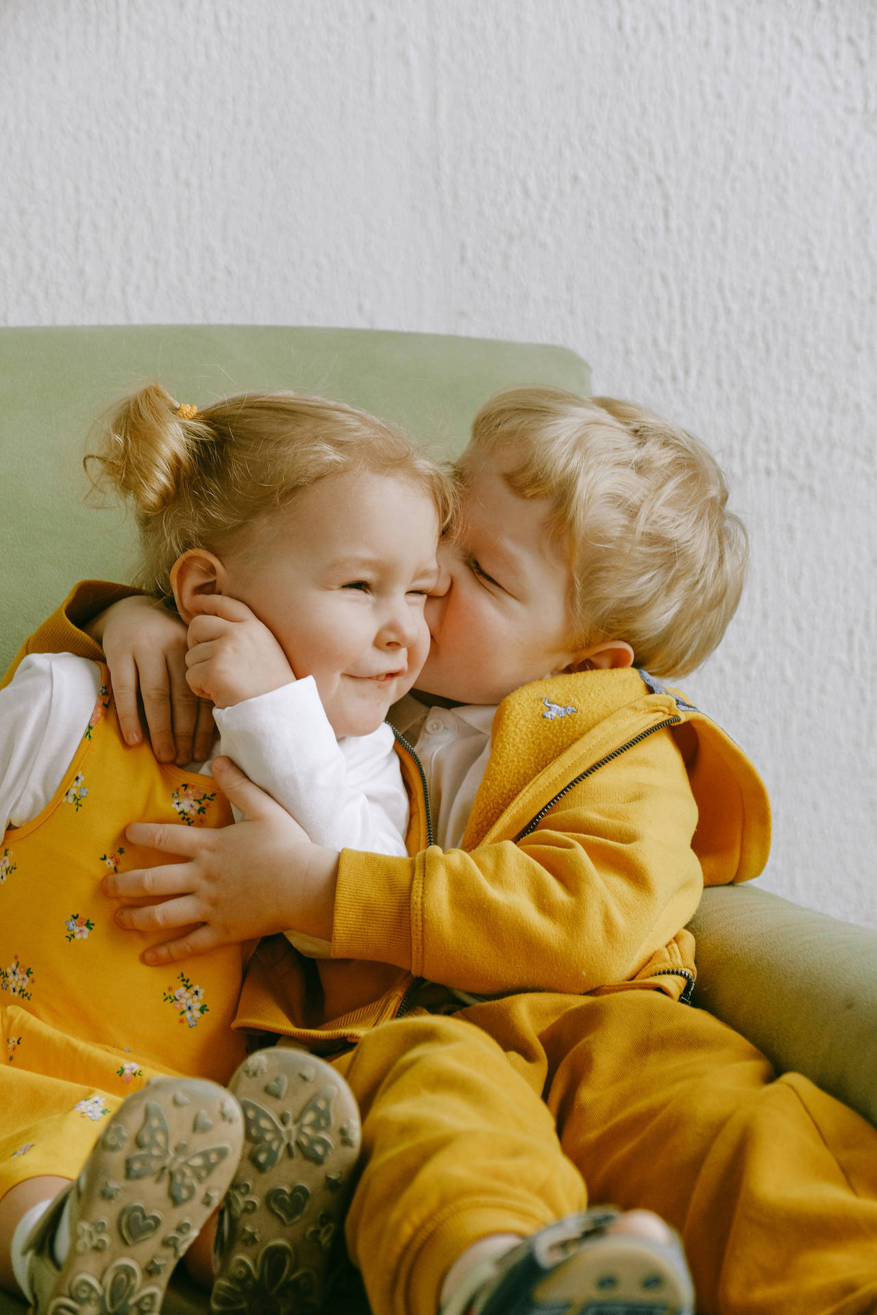 Cute Baby Boy Kissing Little Girl Background