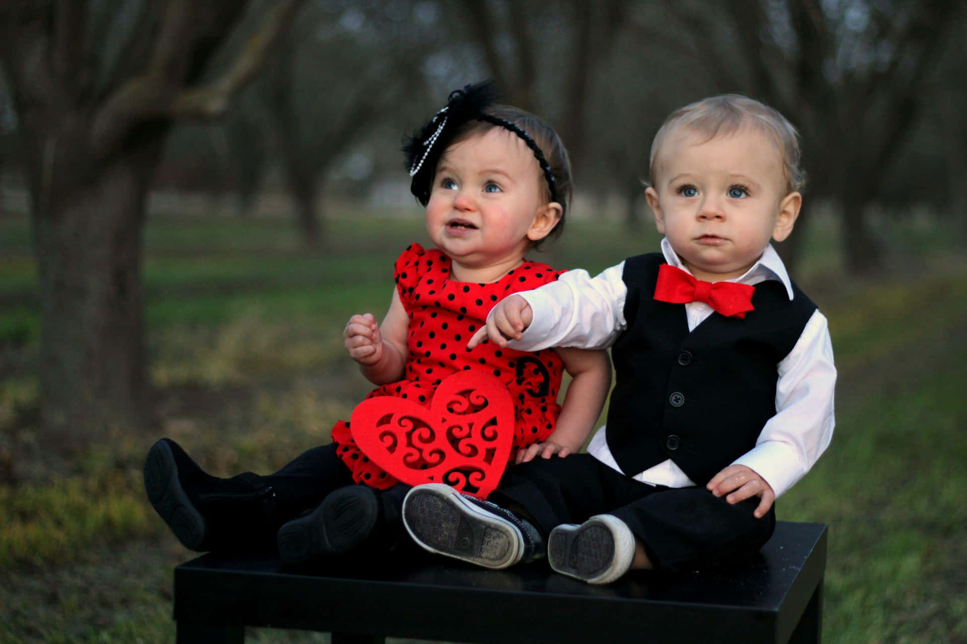 Cute Baby Couple Formal Black & Red Attire Background