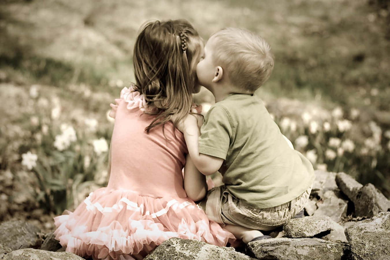 Cute Baby Couple Kissing In The Garden Background