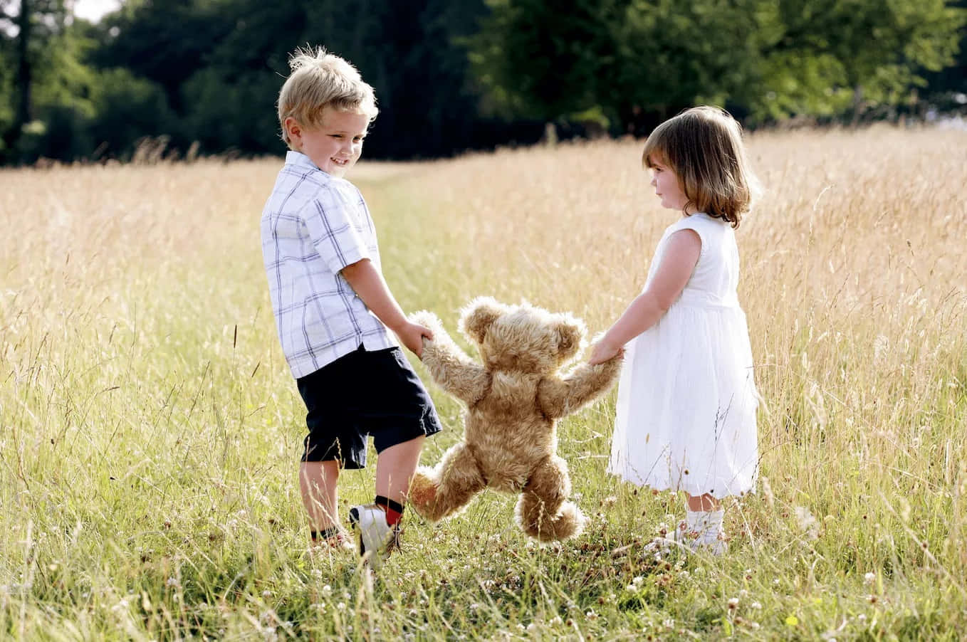 Cute Baby Couple Playing Teddy Bear Background