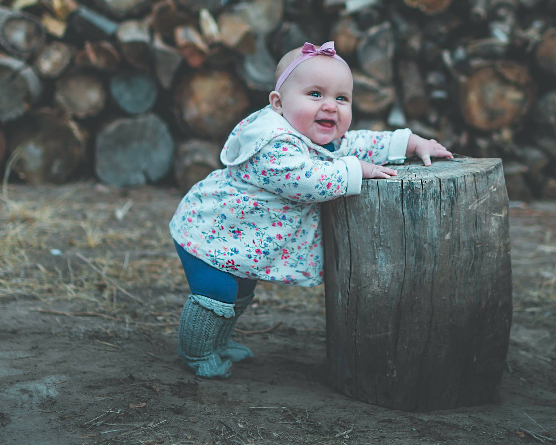 Cute Baby Leaning On Tree Stump