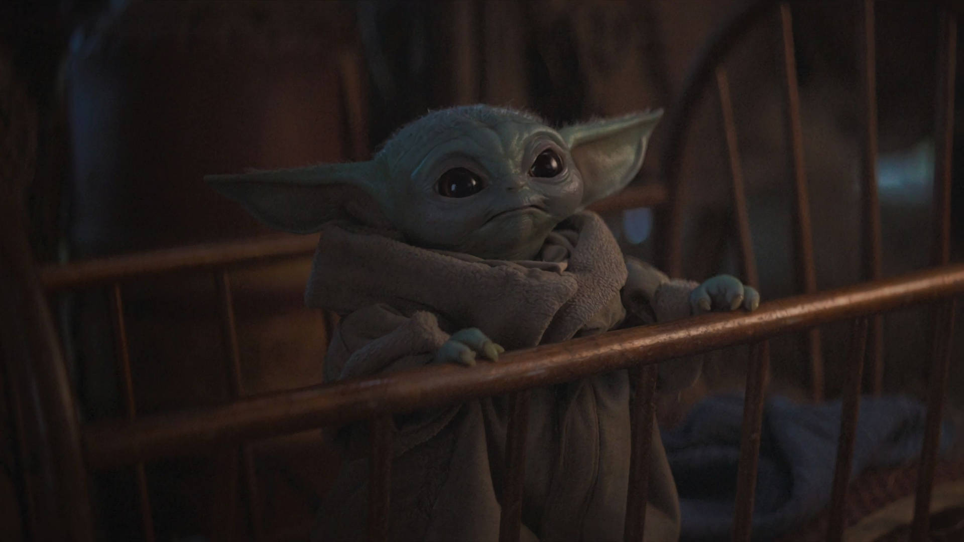 Cute Baby Yoda On Crib Background