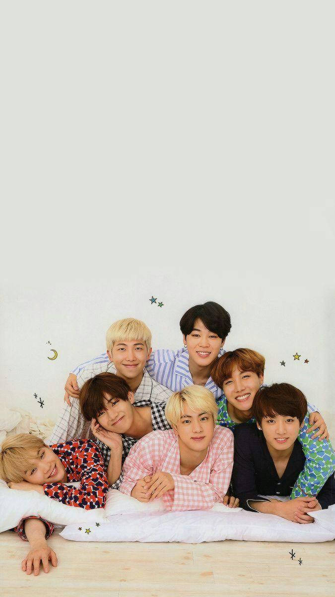 Cute Bts Group Lying Down To Sleep Background