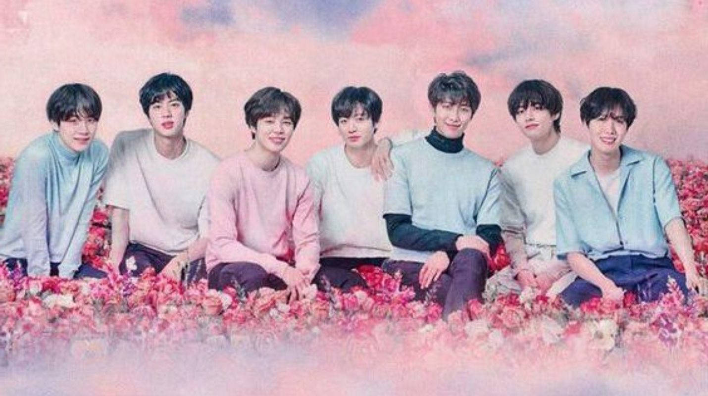 Cute Bts Group On A Pink Flower Field Background
