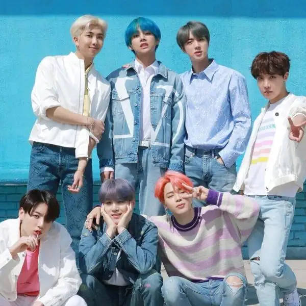 Cute Bts Group Poses Together On A Blue Wall Background