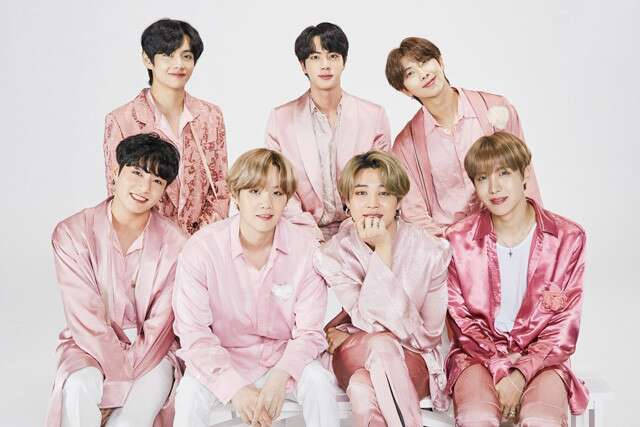 Cute Bts Group Wearing Pink Silk Suits Background