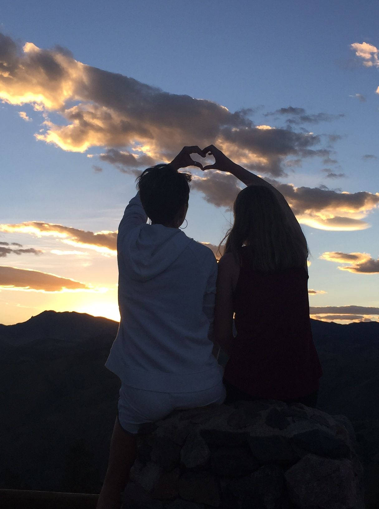 Cute Couple Making Heart At Sunset Background