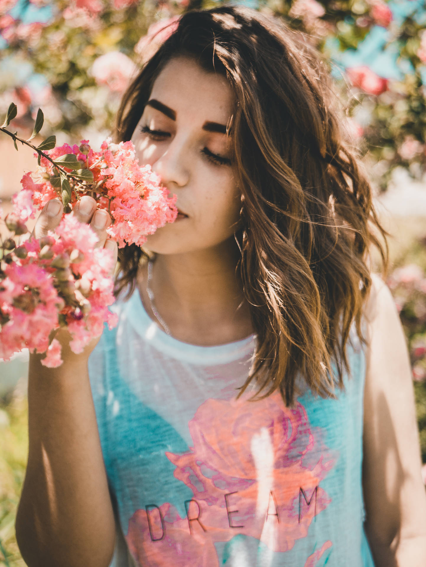 Cute Girl Sniffing Pink Flowers Background