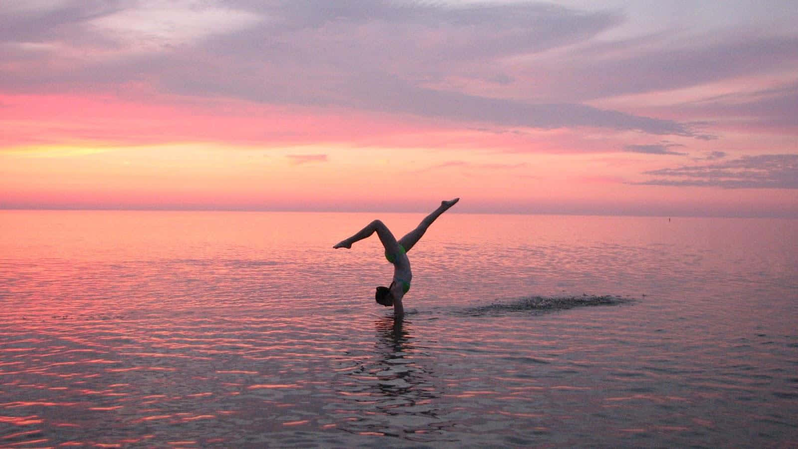Cute Gymnastics Handstand On Beach Background