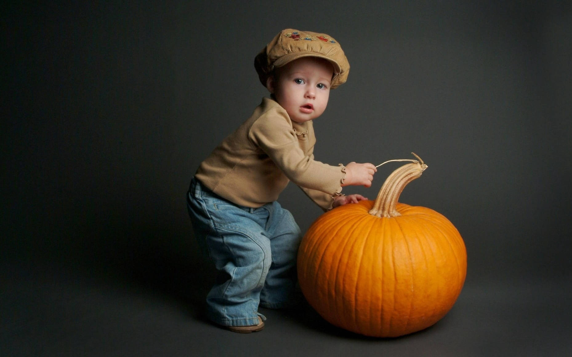 Cute Halloween Toddler Over Pumpkin Background