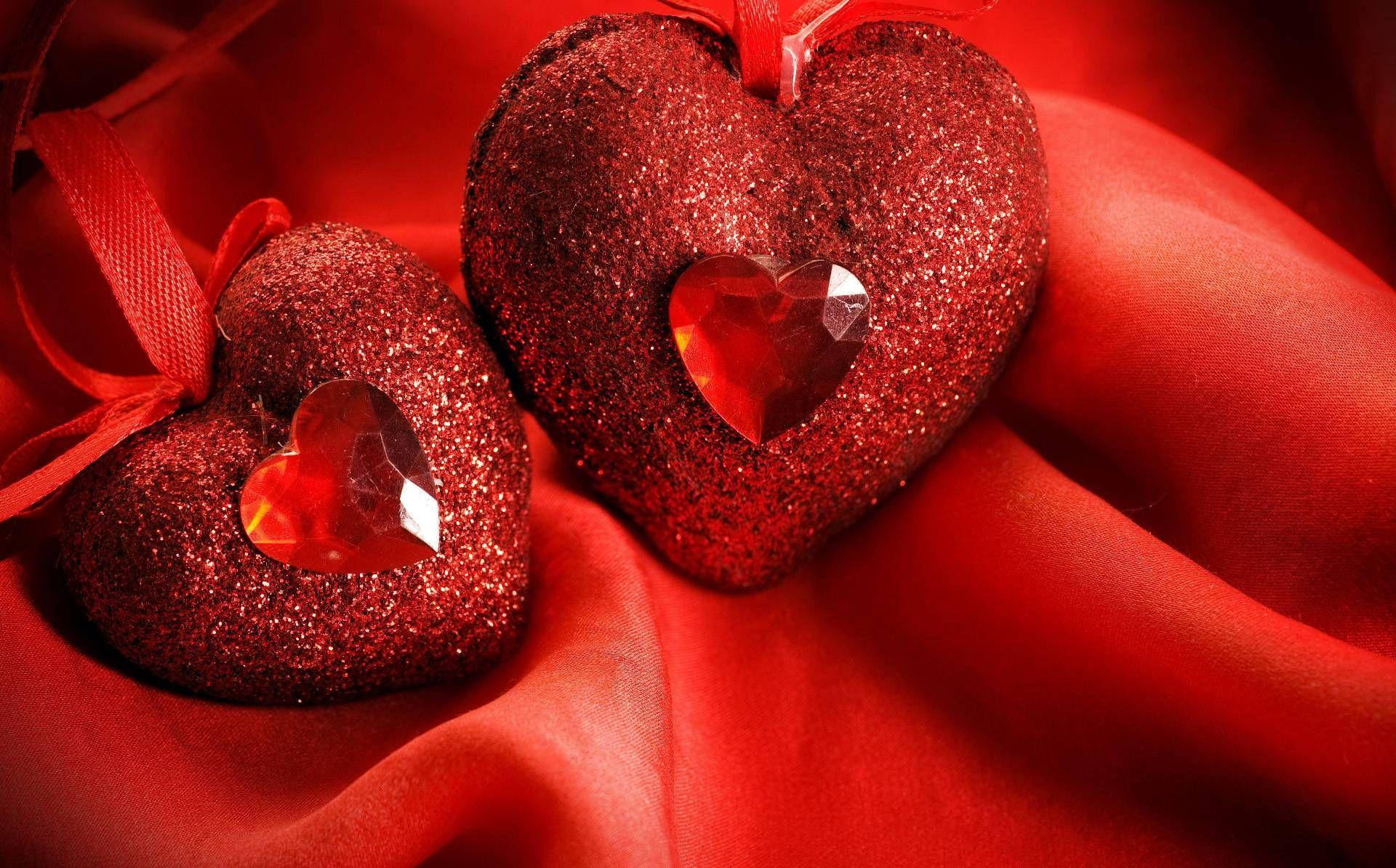 Cute Heart Gems On Red Pillows Background