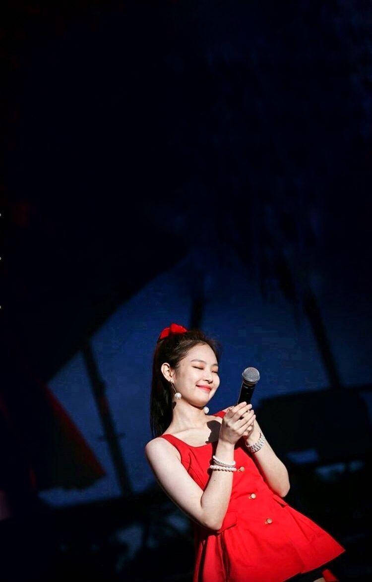 Cute Jennie Smiling In Red Dress Background
