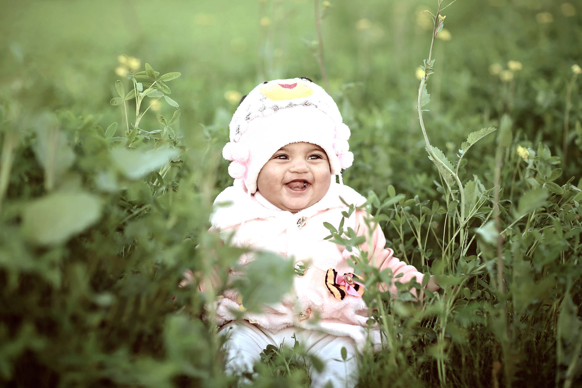 Cute Laughing Baby On Wild Grass
