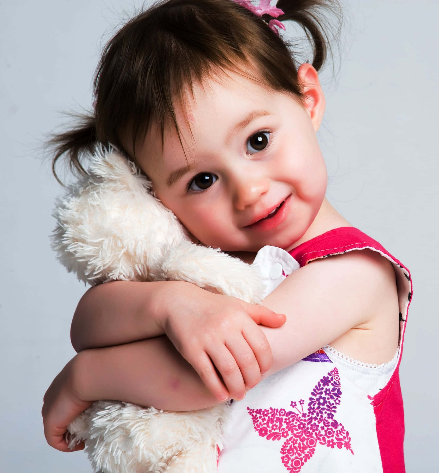 Cute Photo Of A Young Girl Hugging Her Tangible White Stuffed Toy Background