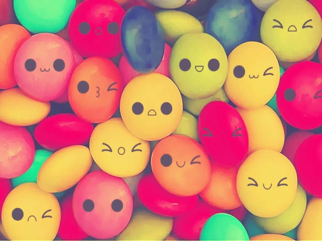 Cute Round Candies With Faces Background