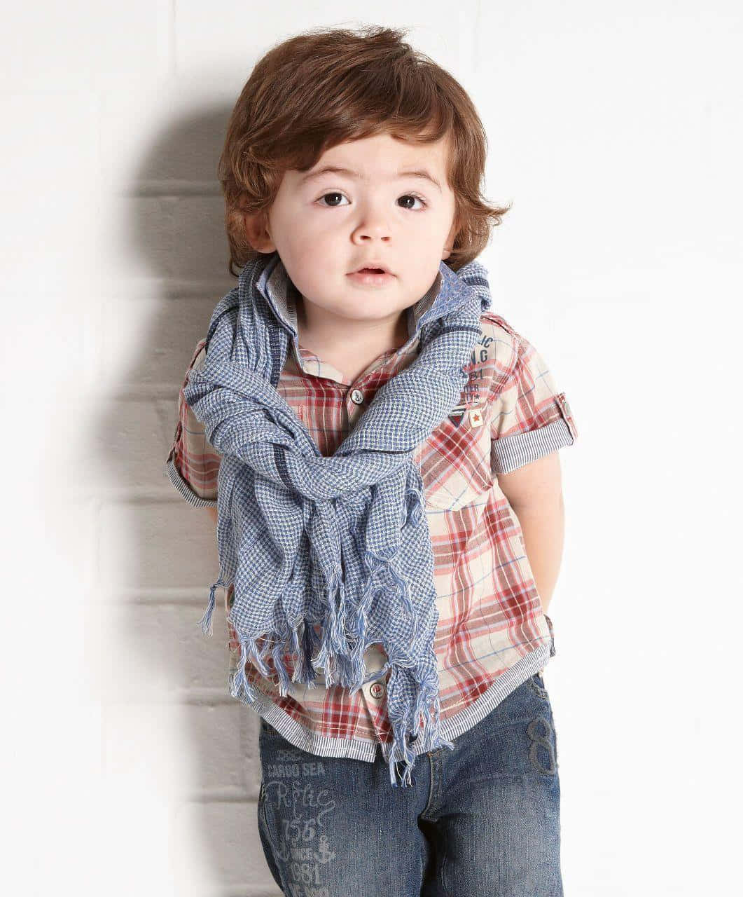 Cute Stylish Boy With Blanket Scarf Background