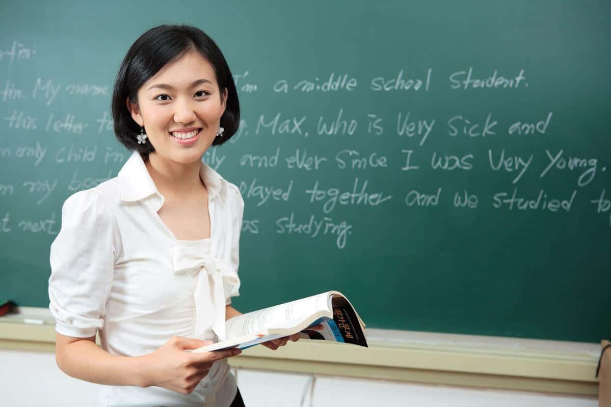 Cute Teacher On Blackboard Background