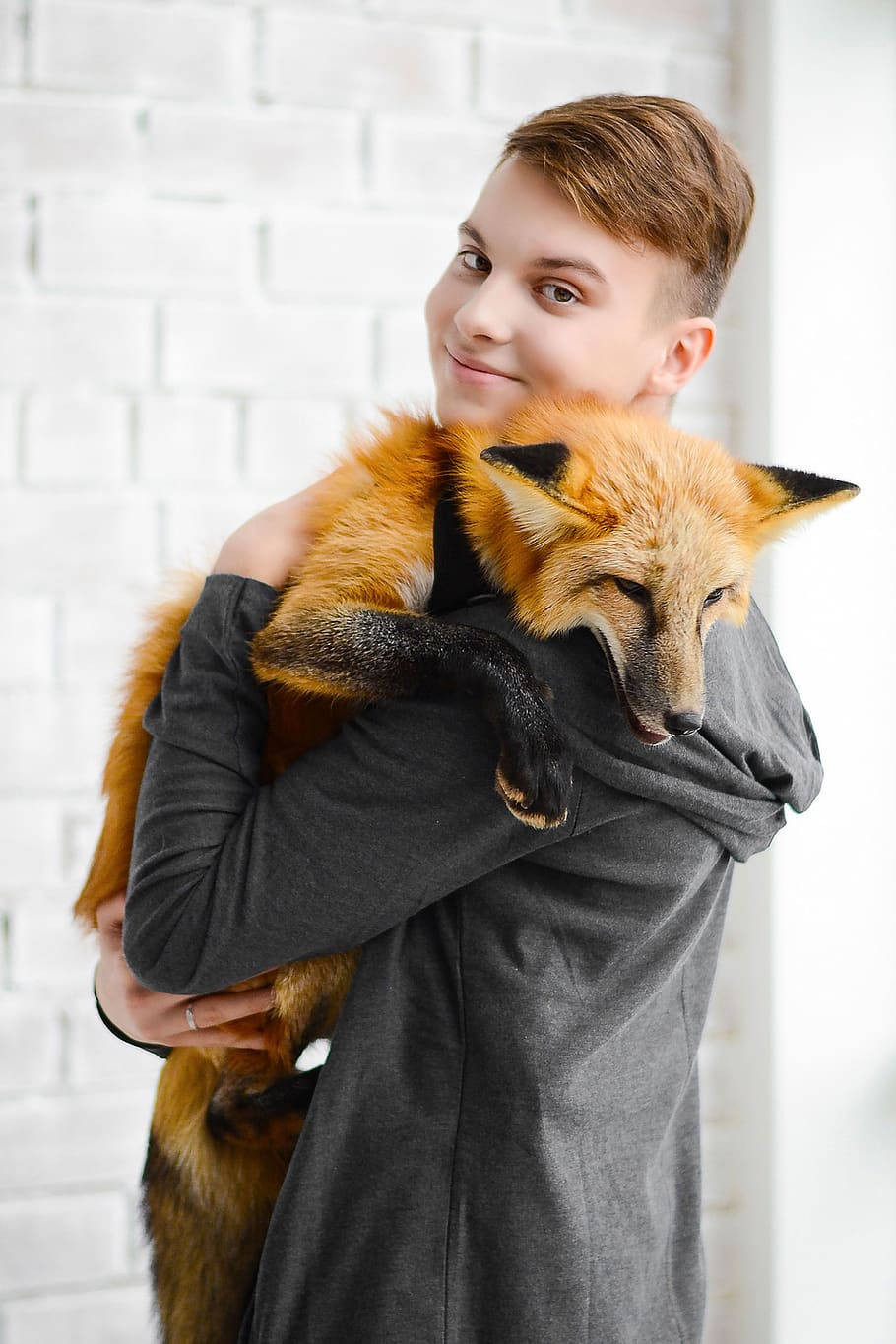 Cute Tomboy Holding A Fox Background