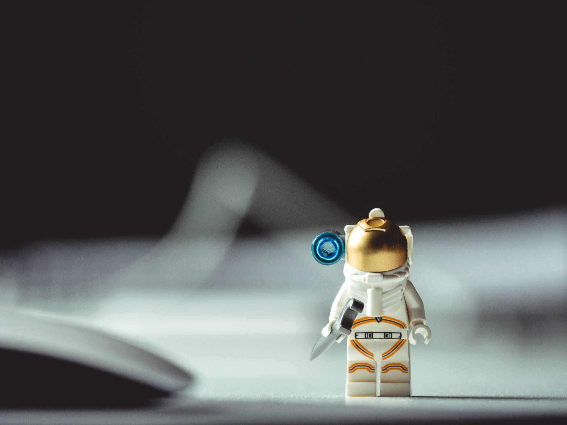 Cute Toy Astronaut In Space Background
