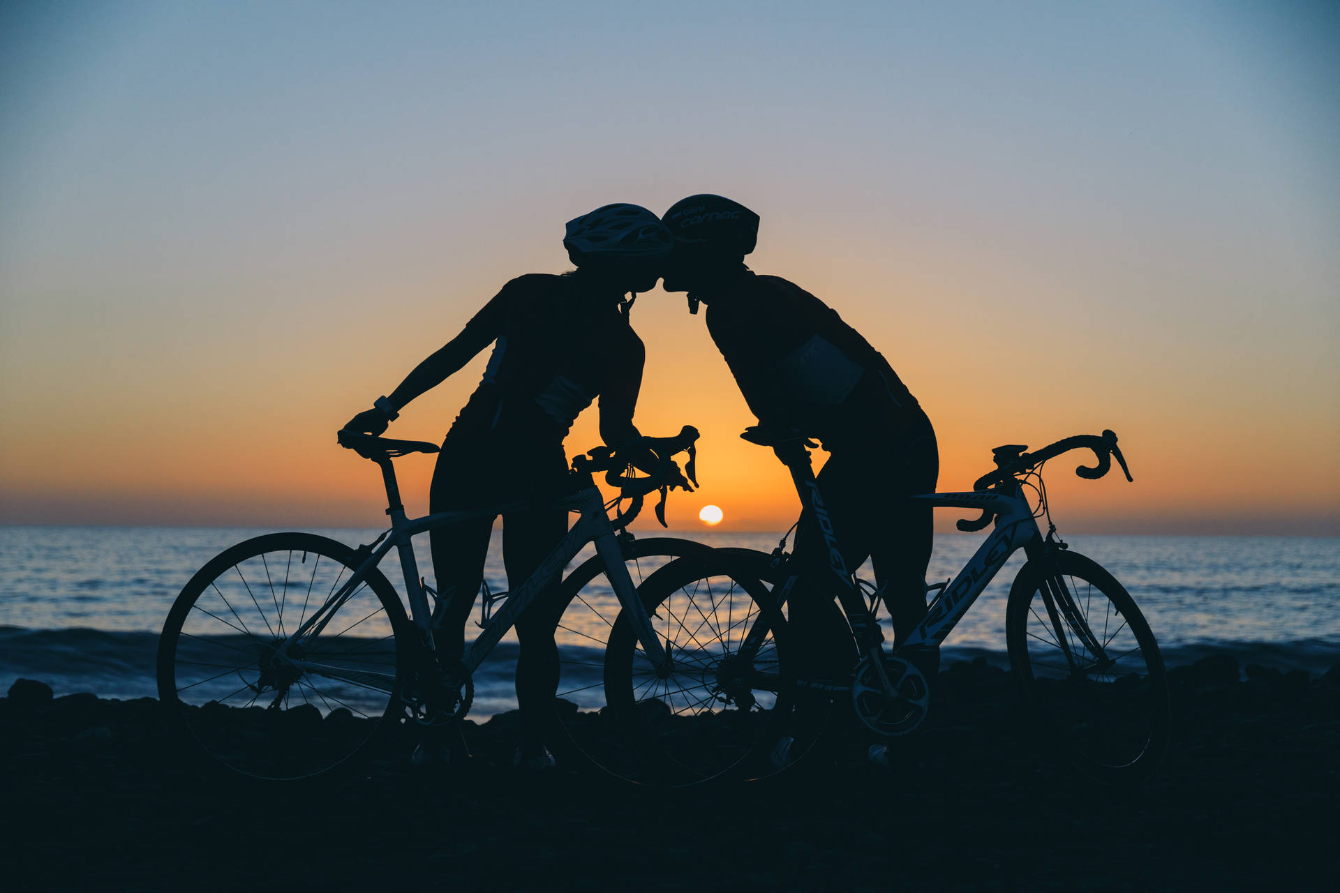 Cycling Couple Silhouette Sunset Background