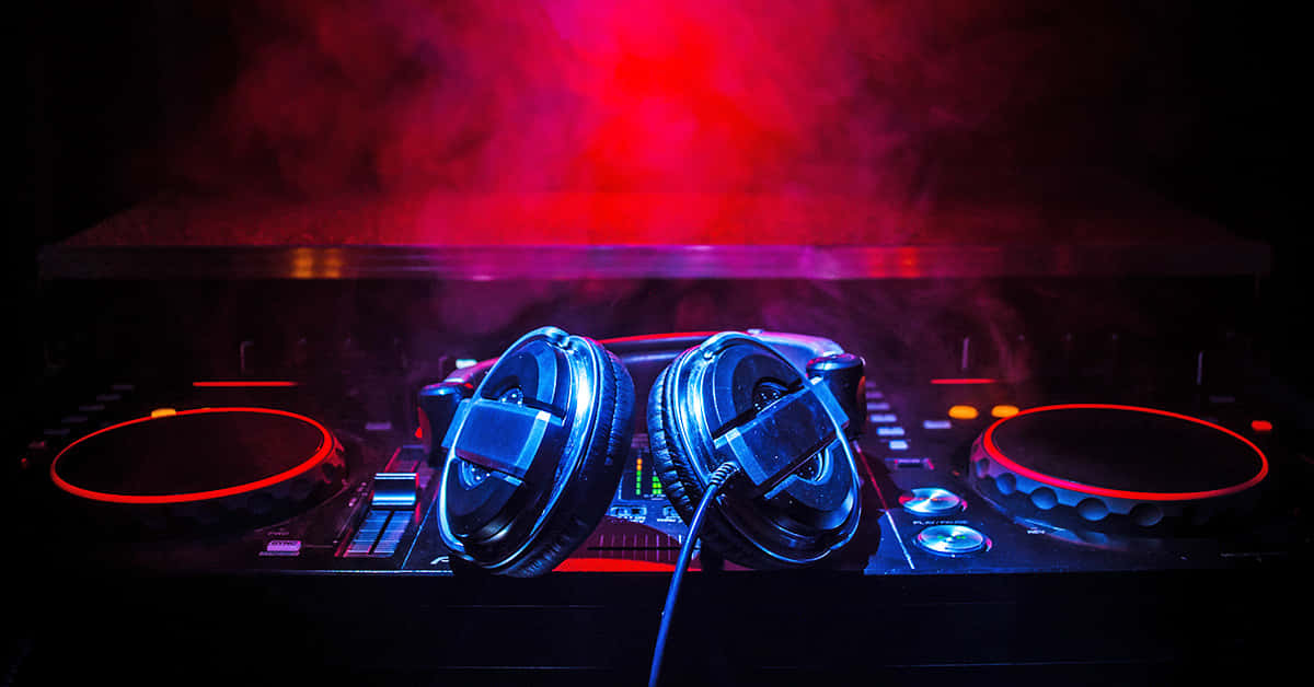 D J Headphonesand Mixer Under Red Lights Background
