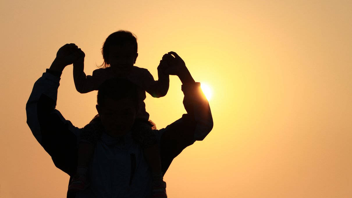 Dad And Baby Watching Sunset Background