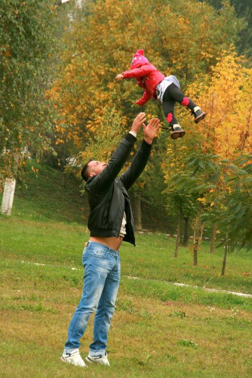 Dad Playfully Tossing His Child