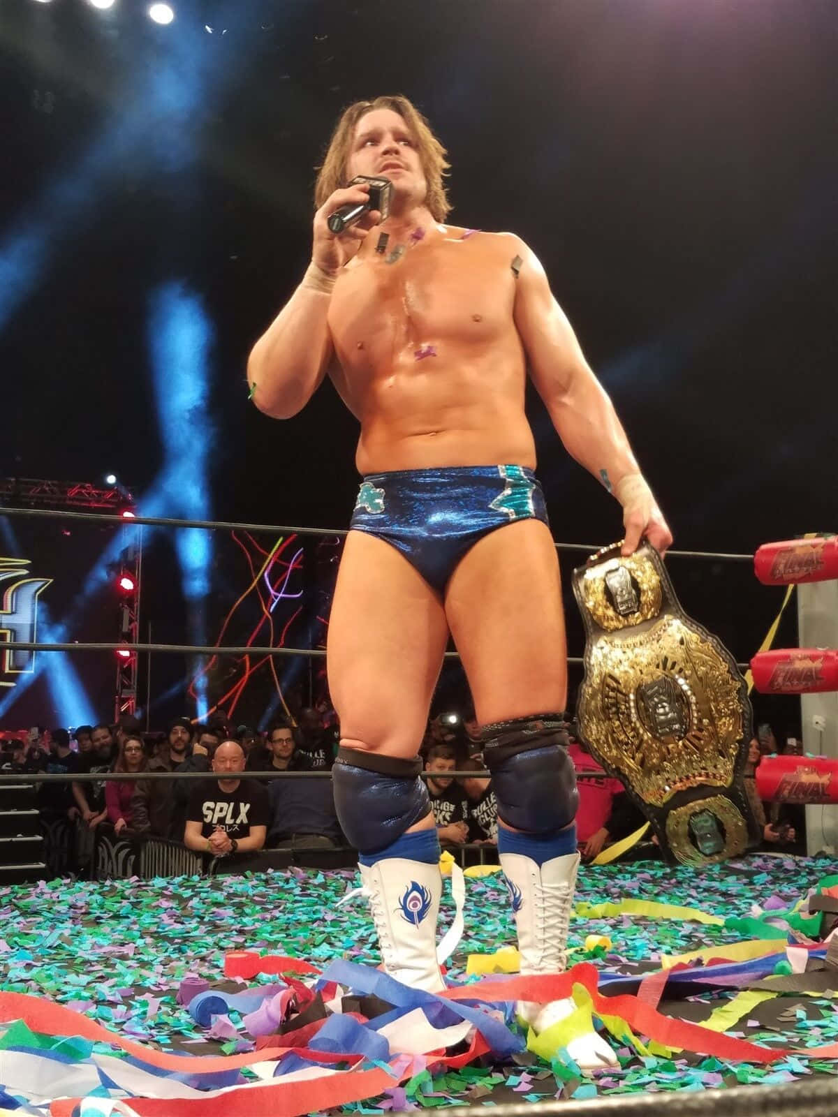 Dalton Castle Triumphantly Holding Aew Championship Belt Background