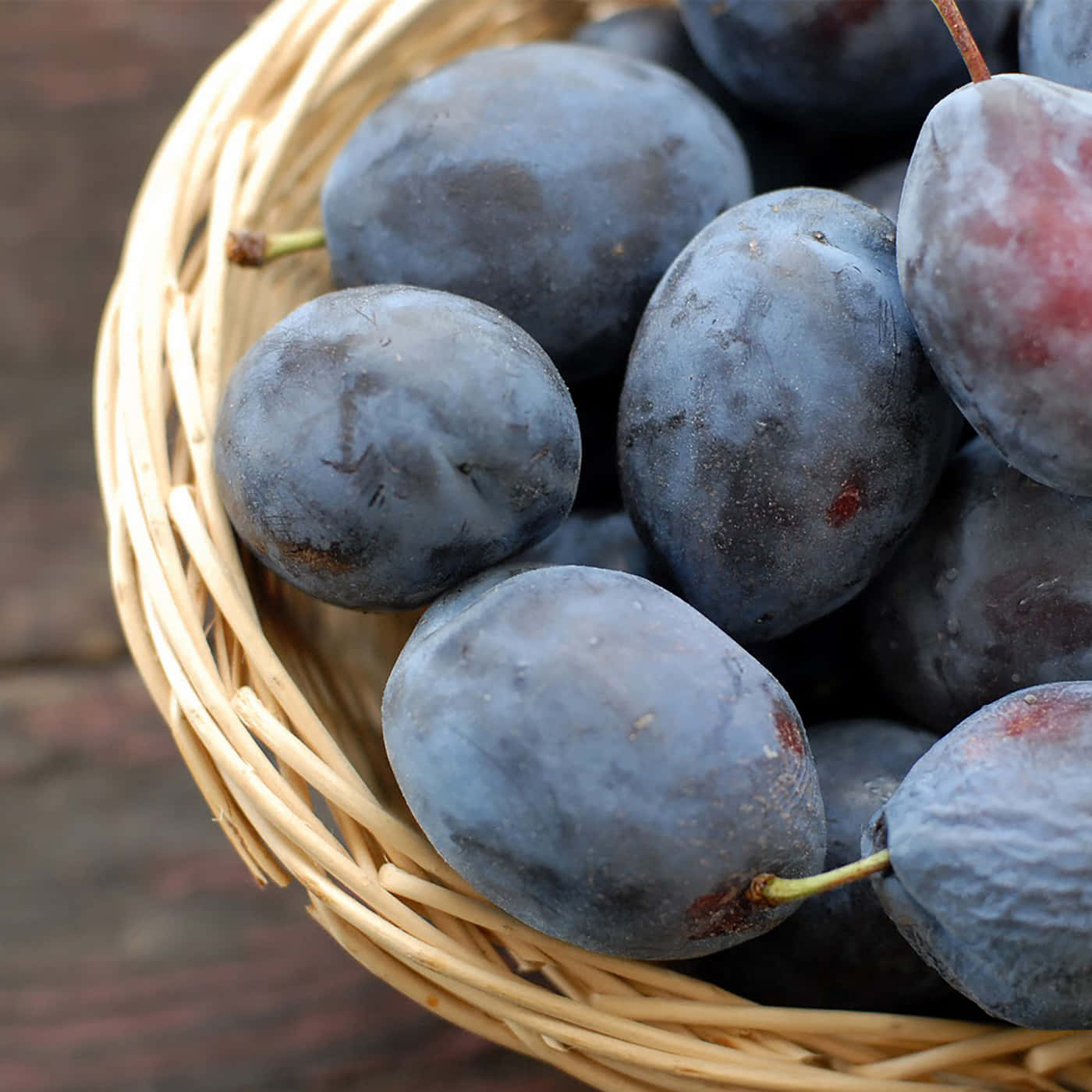 Damson Plums On A Wicket Basket Background