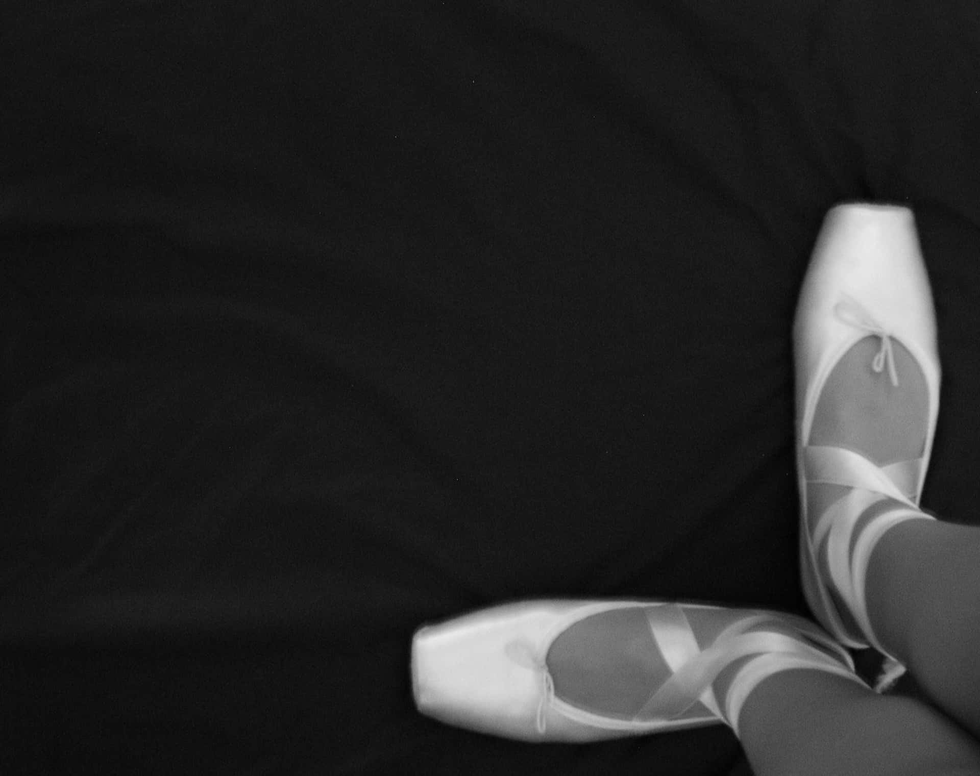Dancing Through Monochrome: Black And White Pointe Ballet Shoes Background