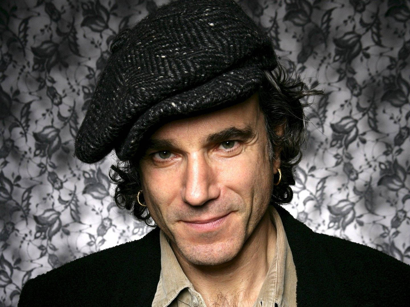 Daniel Day-lewis Captivating Stance Against A Vibrant Floral Background Background