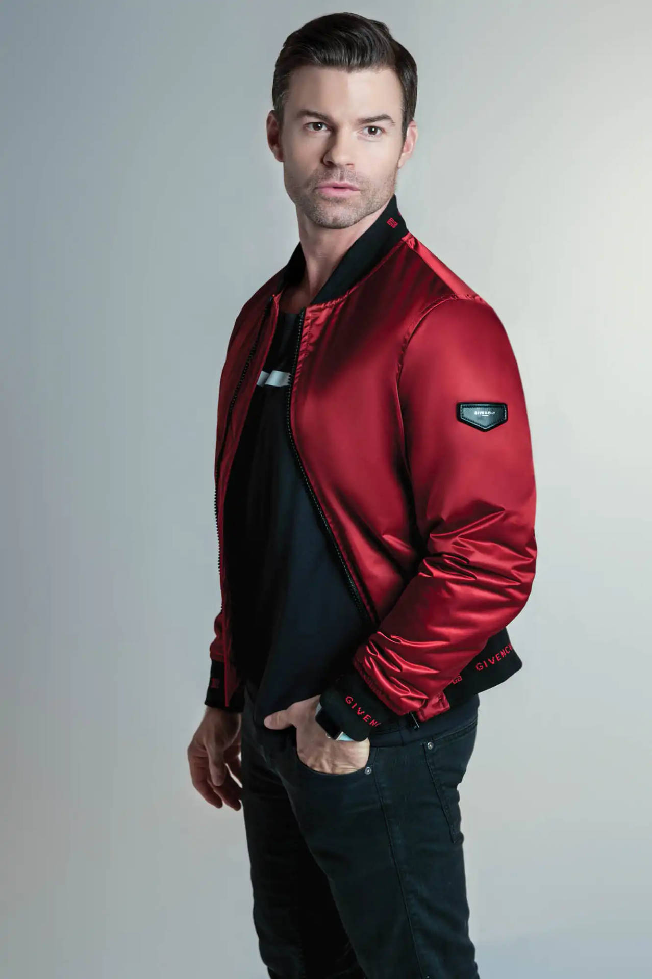 Daniel Gillies Displays Sophisticated Style In A Red Jacket Background